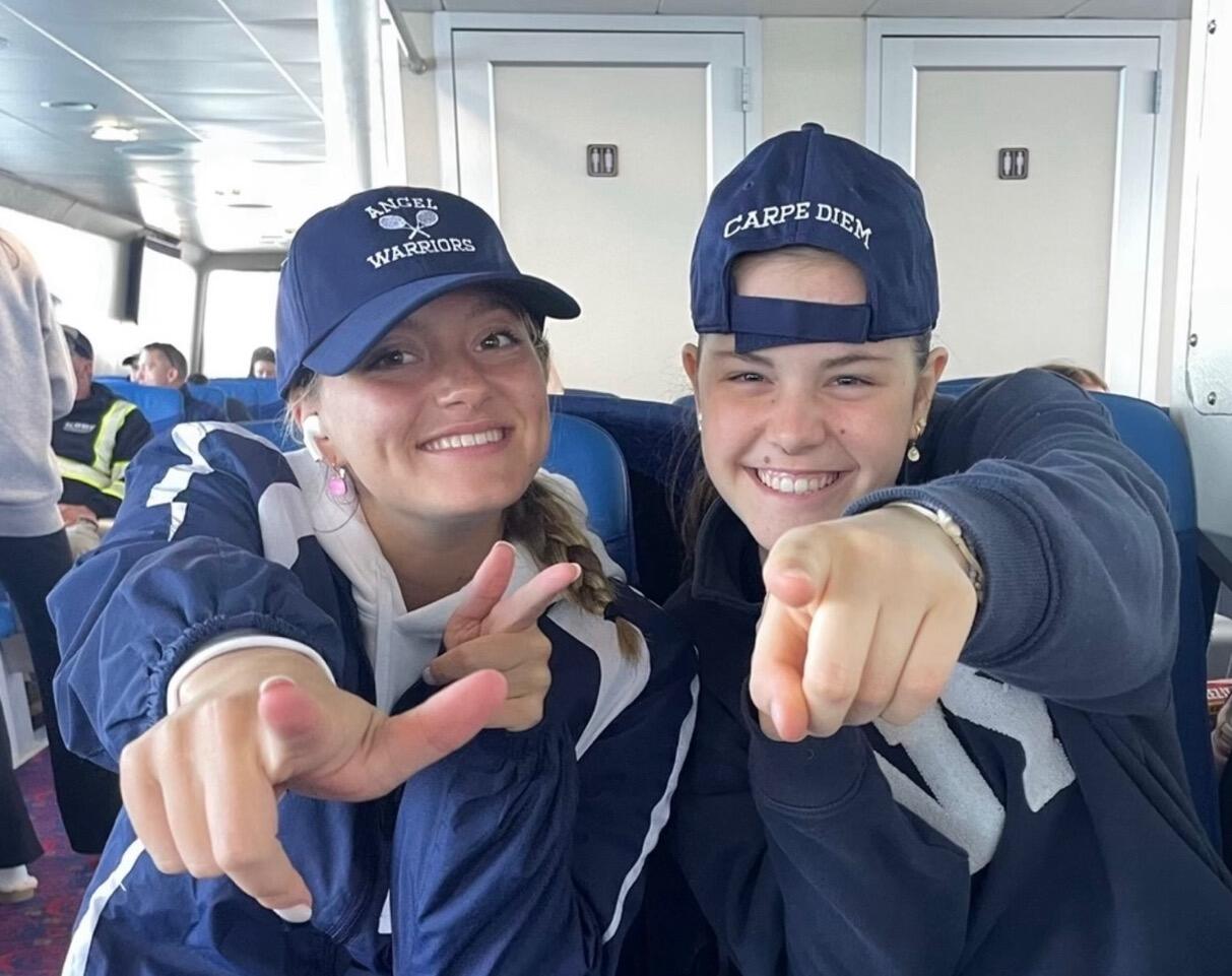 Two Angel Warriors in navy caps reading Angel Warriors and Carpe Diem